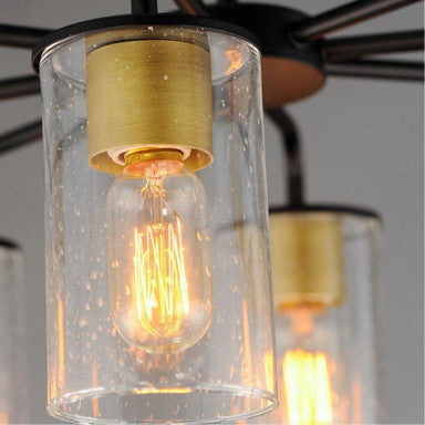 Maxim Lighting 11848CDSN Sleek Chandelier close-up of Antiqued Brass socket cover and Clear Seeded glass cylinder shade with Edison bulb