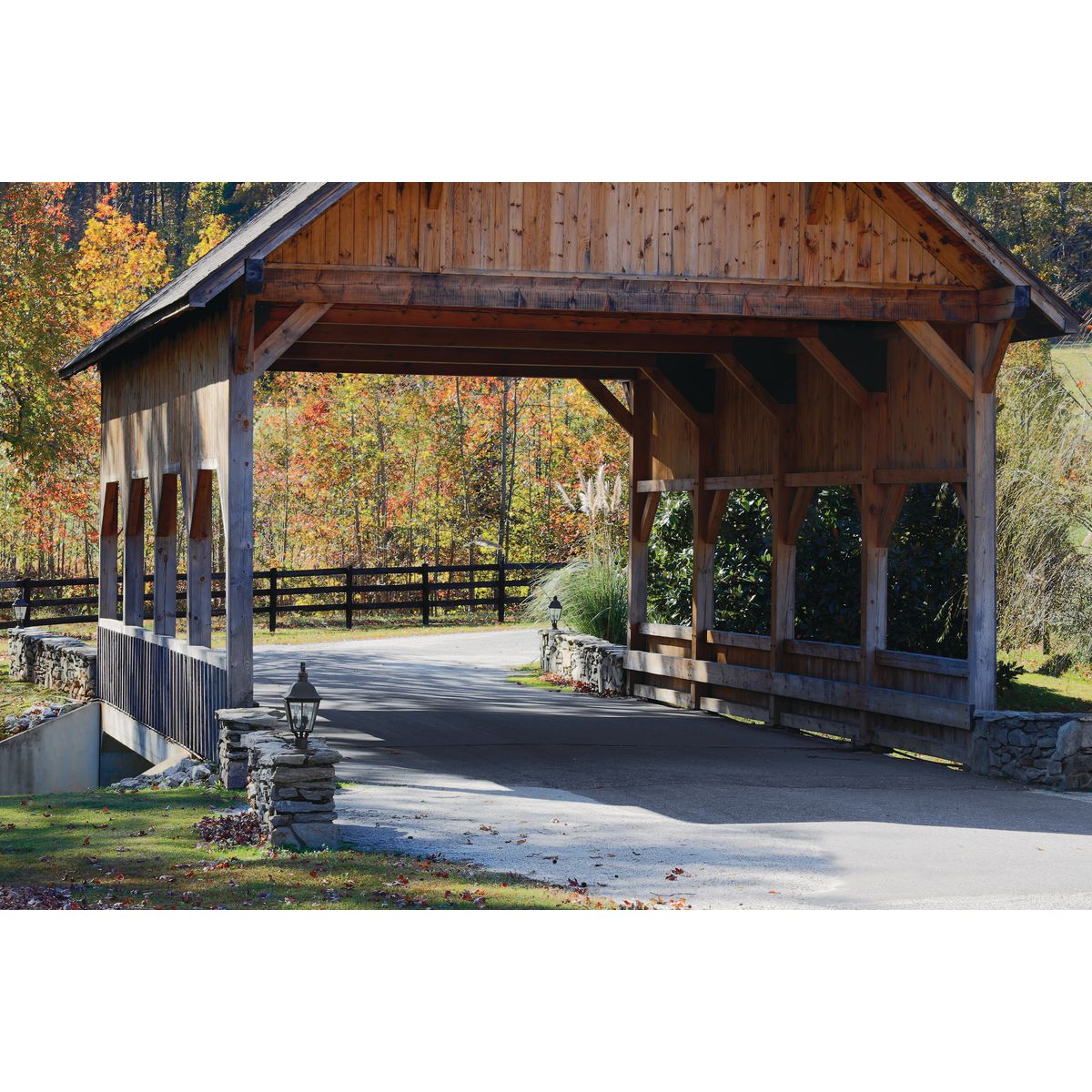 Progress Lighting Andover outdoor post lantern installed at a covered bridge driveway