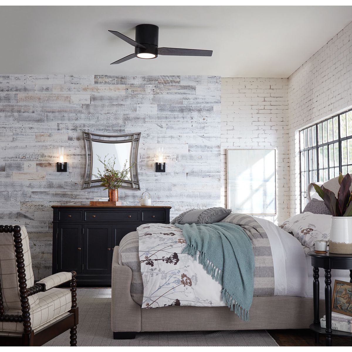 Progress Lighting Clarion matte black bath vanity wall lights shown in a bedroom setting