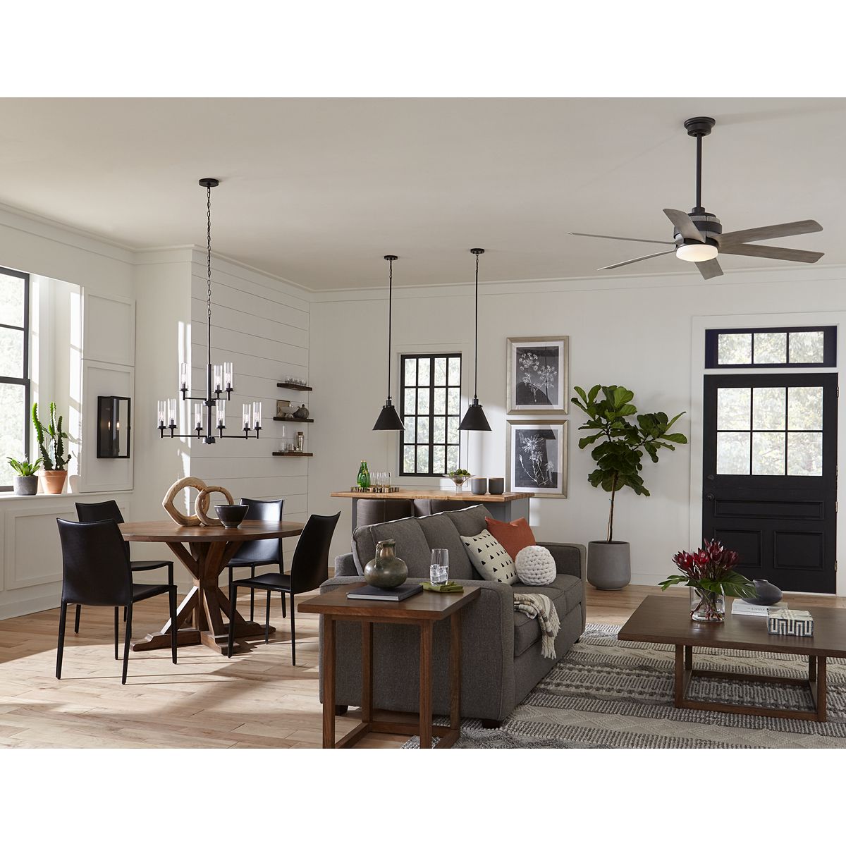 Progress Lighting Kellwyn matte black chandelier shown in a dining and living room