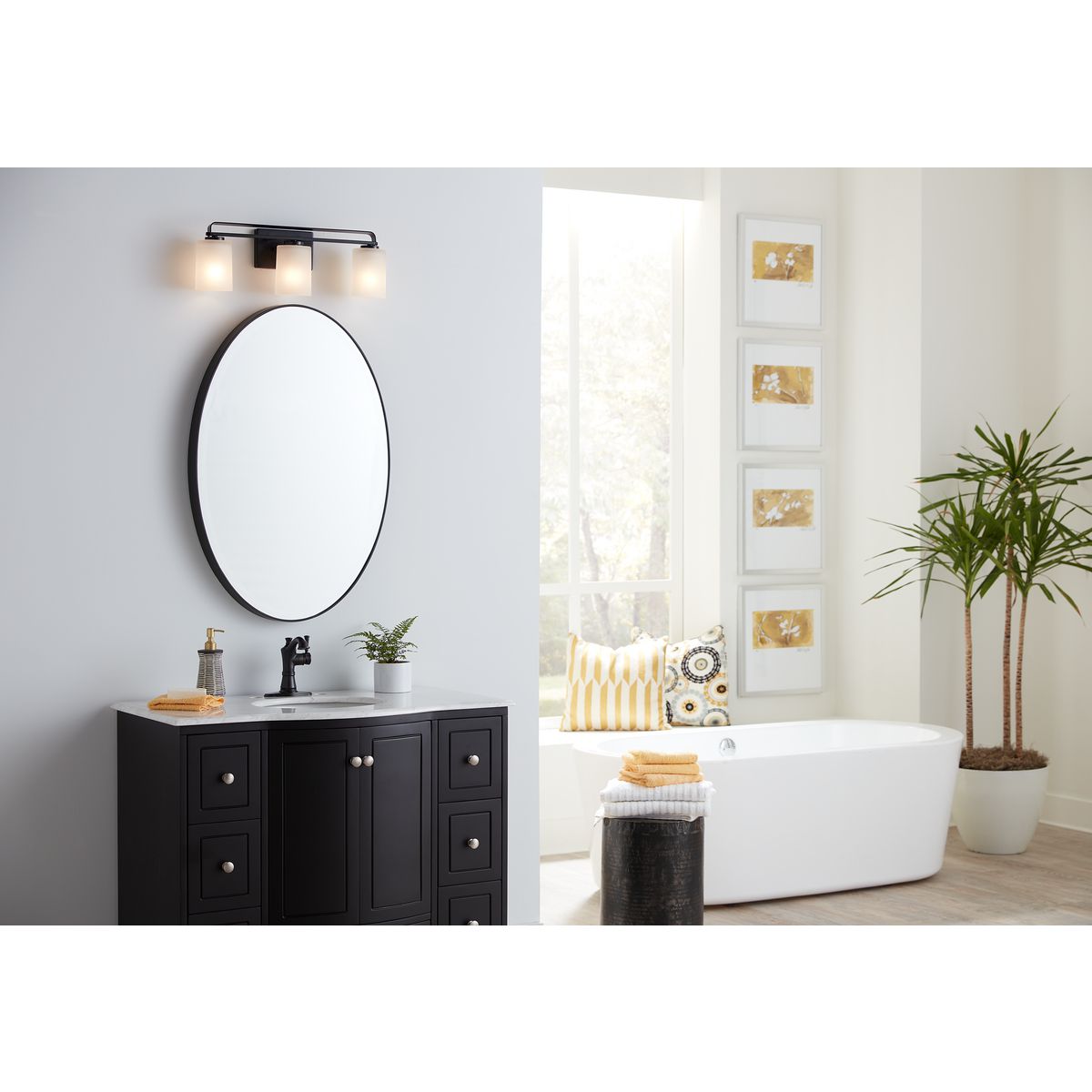 Progress Lighting League matte black 3 light bath vanity wall light installed above bathroom mirror