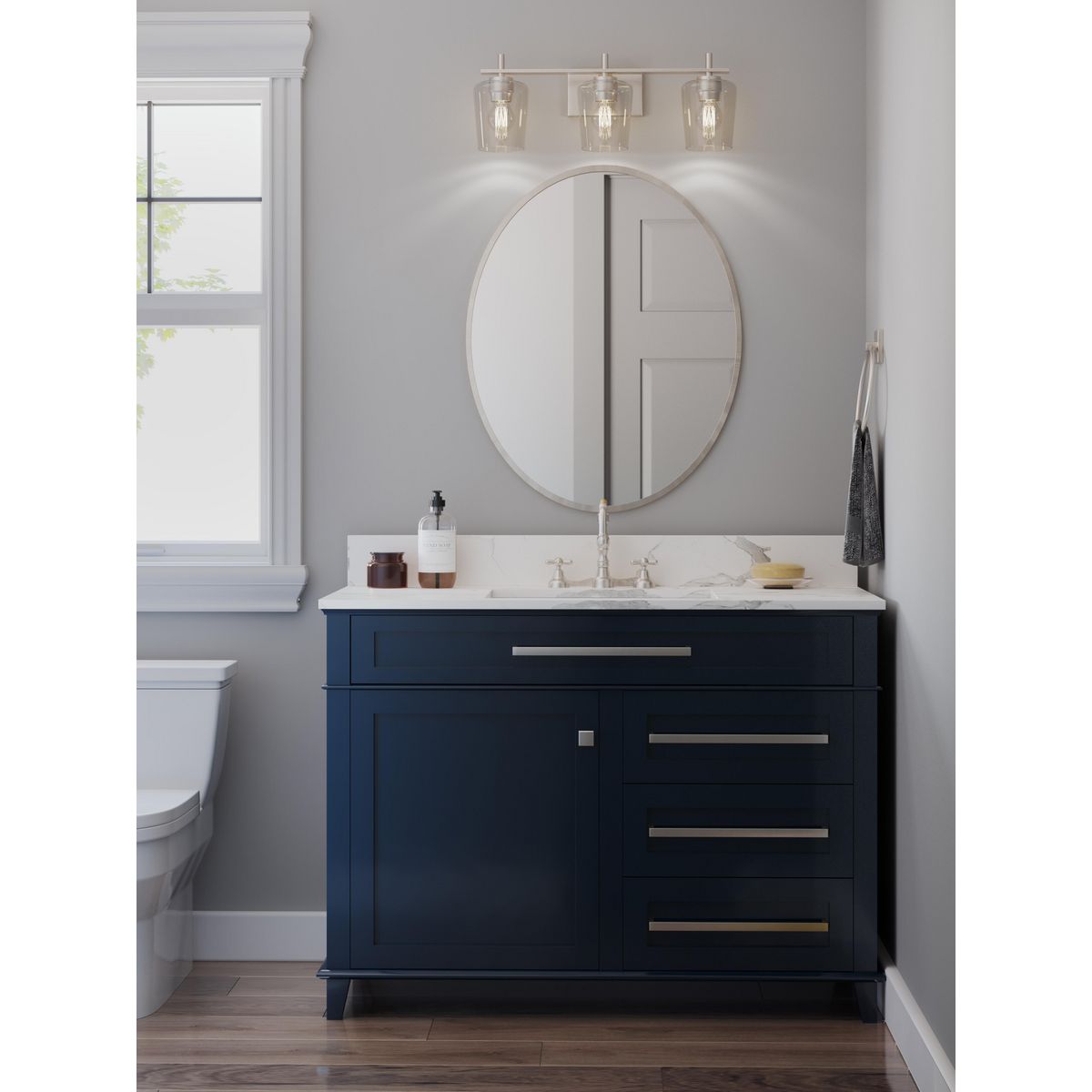 Progress Lighting Calais 3 light brushed nickel bath vanity wall light installed above bathroom mirror