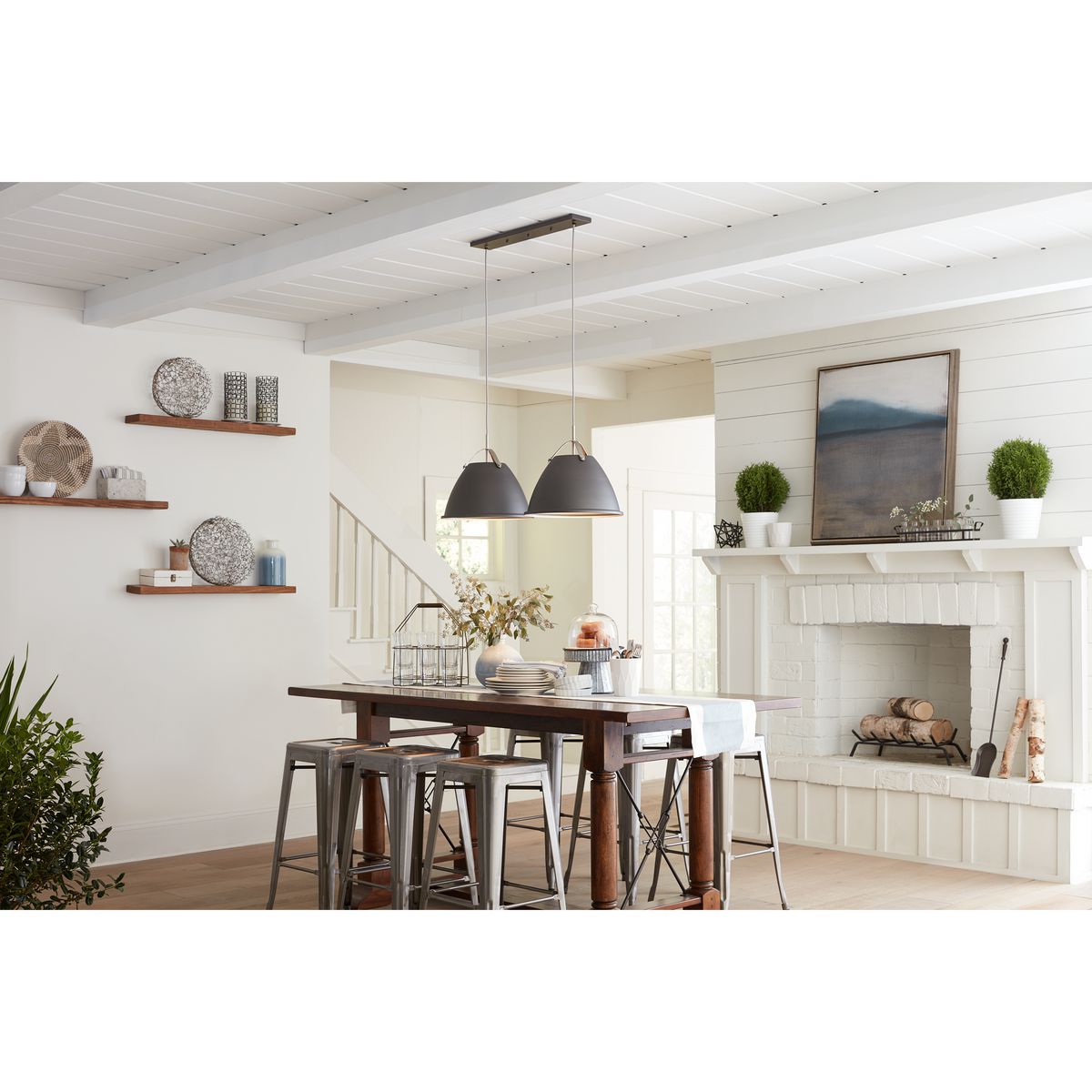 Progress Lighting Tre graphite pendant lights above dining table