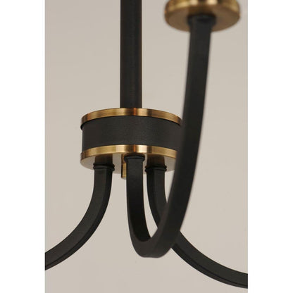 Center hub detail of Maxim Lighting 11375BKAB Charlton Chandelier showing black finish with antique brass ring accents
