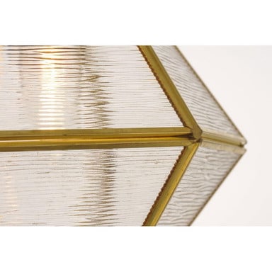 Close-up detail of Maxim Lighting 11555BKBUB Adorn Mini Pendant ripple glass texture and brass frame corner