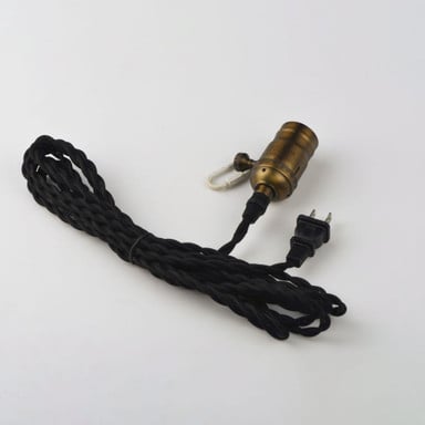 Maxim Lighting 12120BKAB Early Electric Pendant close-up of antique brass socket with black twisted cord and plug