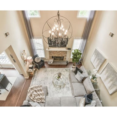 Maxim Lighting 25147ARPN Orbit 12 Light Pendant installed in a two-story living room, overhead view