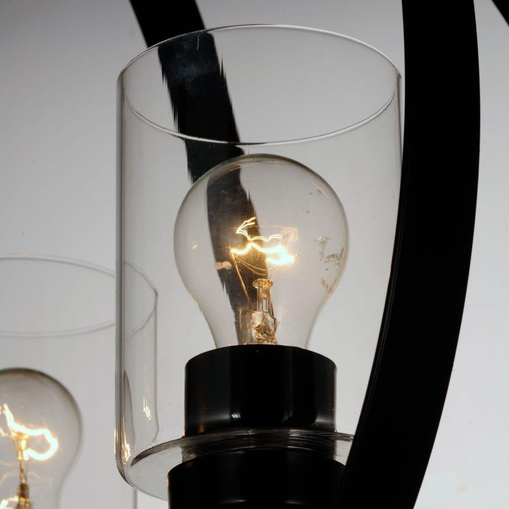 Maxim Lighting 25254CLBK Sentinel Pendant close-up detail of clear glass cylindrical shade with illuminated bulb on black metal frame