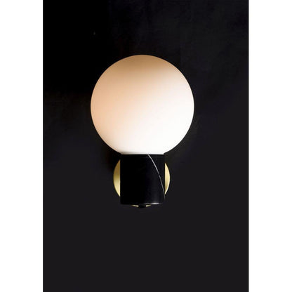 Maxim Lighting 26030SWSBRBK Vesper 1 Light Wall Sconce lit against dark background highlighting warm globe glow