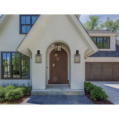 Maxim Lighting 30056CLBKGLD Neoclass Outdoor Wall Lantern shown on home entryway lifestyle photo