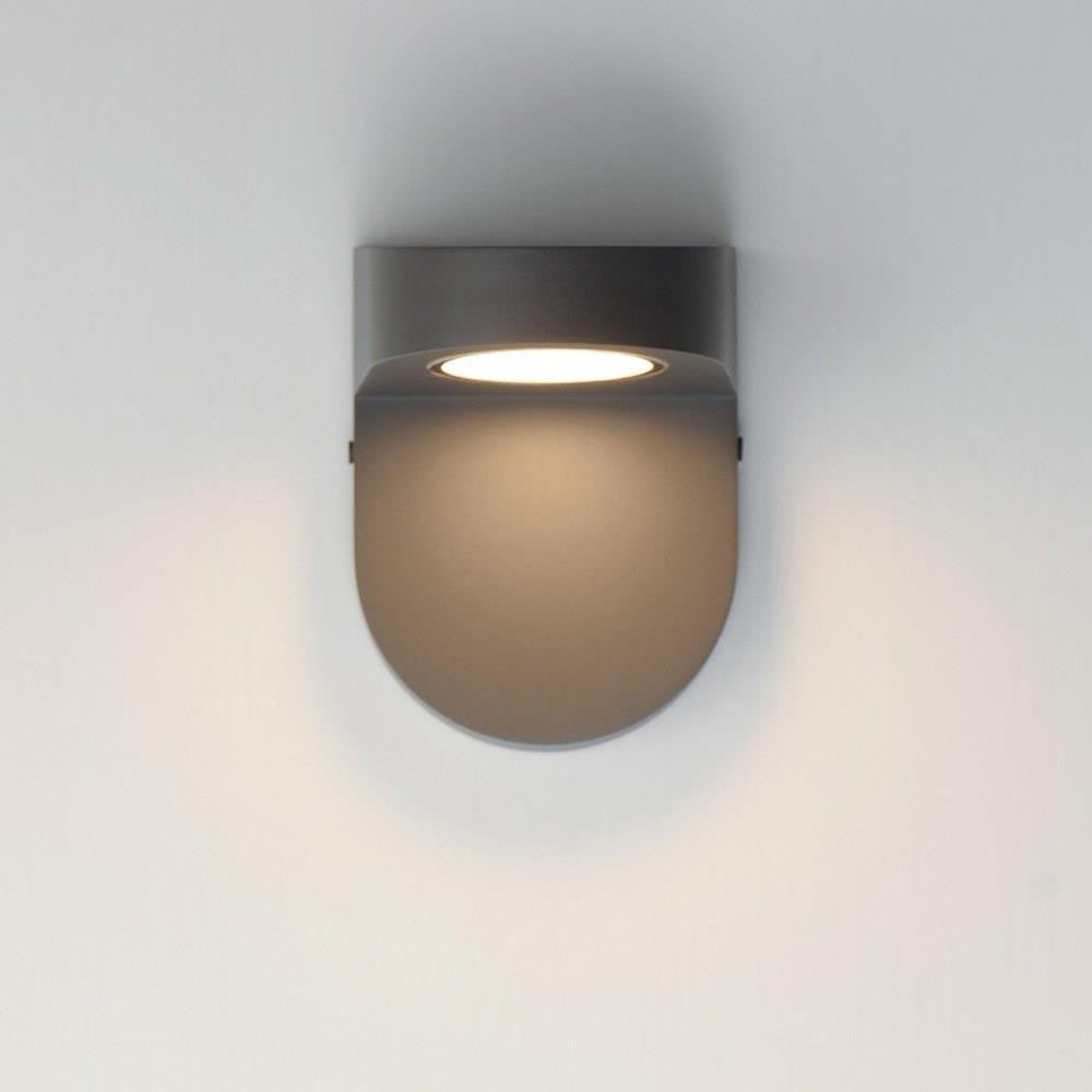 Maxim Lighting 86198ABZ Ledge LED Wall Sconce in Architectural Bronze shown illuminated on wall - front angle view