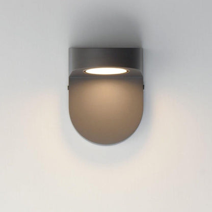 Maxim Lighting 86198ABZ Ledge LED Wall Sconce in Architectural Bronze shown illuminated on wall - front angle view