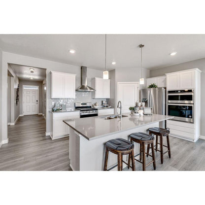Maxim Lighting 90200FTSN Corona Mini Pendant shown installed over a kitchen island in a lifestyle setting