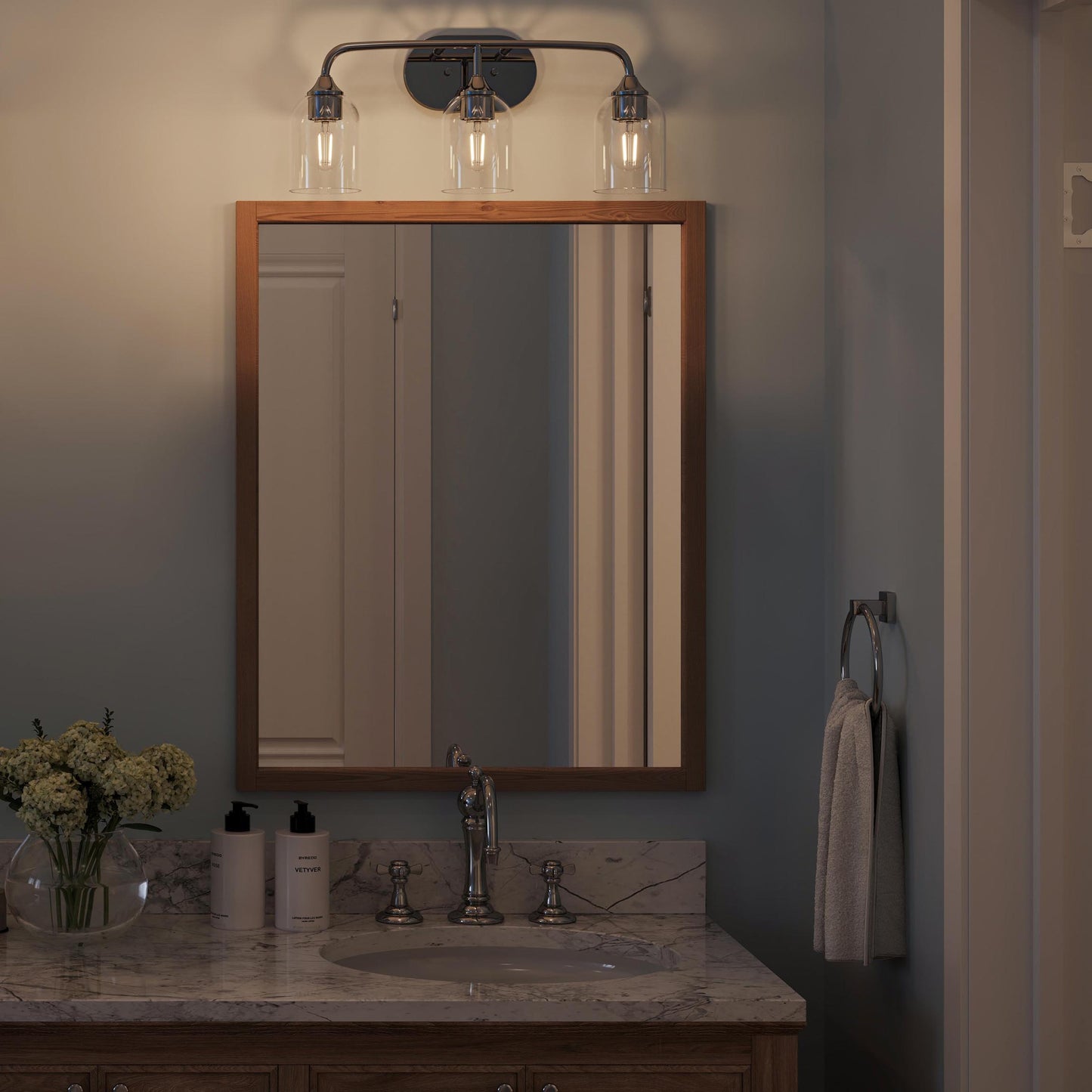 Progress Lighting P300573-015 Ilia 3-Light Bath Vanity Polished Chrome - Nighttime Bathroom Lifestyle Shot