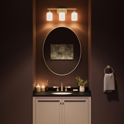Progress Lighting Reines P300579-191 Brushed Gold Bath Vanity illuminated above bathroom mirror - Night Scene