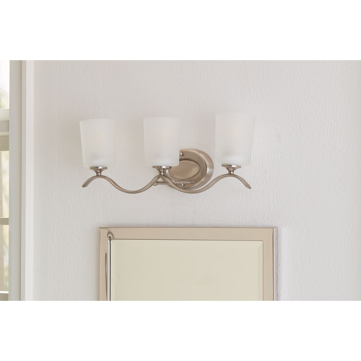 Progress Lighting Inspire 3 light brushed nickel bath vanity wall light installed above mirror