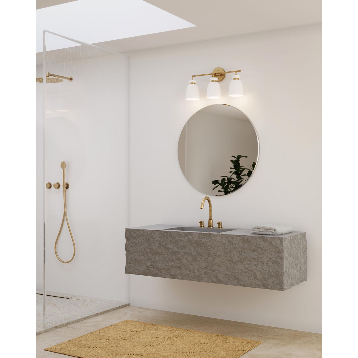 Progress Lighting Lexie 3 light brushed gold bath vanity wall light in bathroom setting