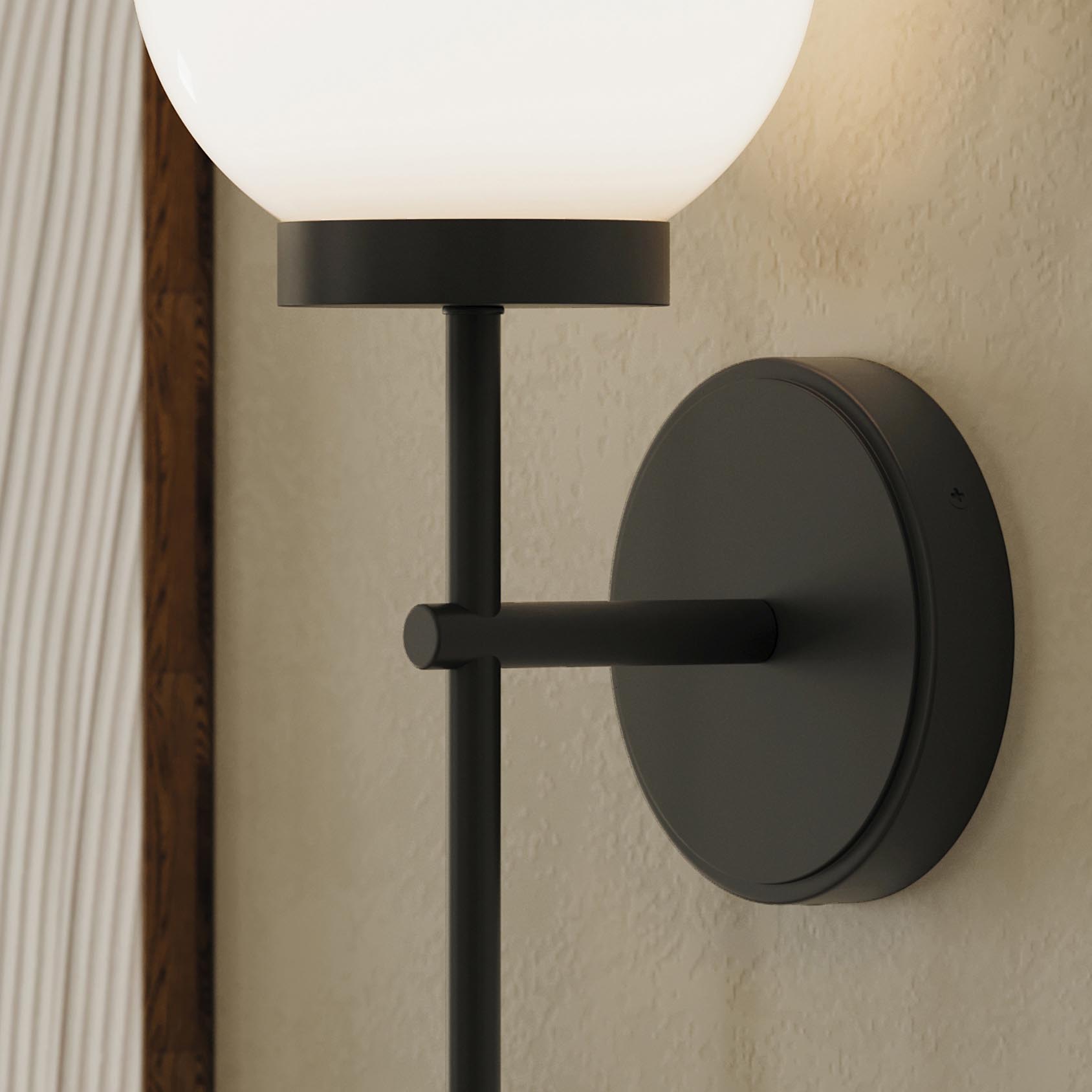 Progress Lighting P710157-31M Rigsby Wall Sconce close-up detail showing matte black canopy and round backplate