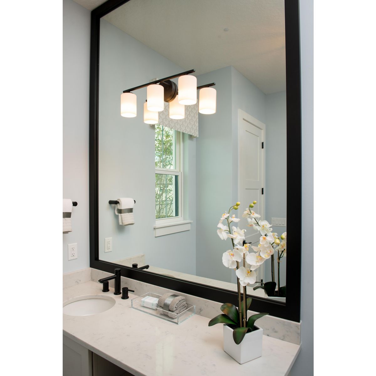 Progress Lighting Replay 3 light antique bronze bath vanity wall light installed above bathroom mirror
