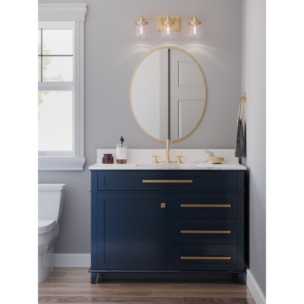 Progress Lighting Hinton 3 light vintage brass bath vanity wall light installed above bathroom mirror