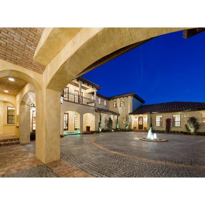 Carriage House VX collection lifestyle photo - grand courtyard estate illuminated at night